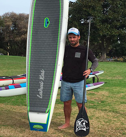 surf education academy sup stand up paddle board coach with a rental SUP at la jolla shores