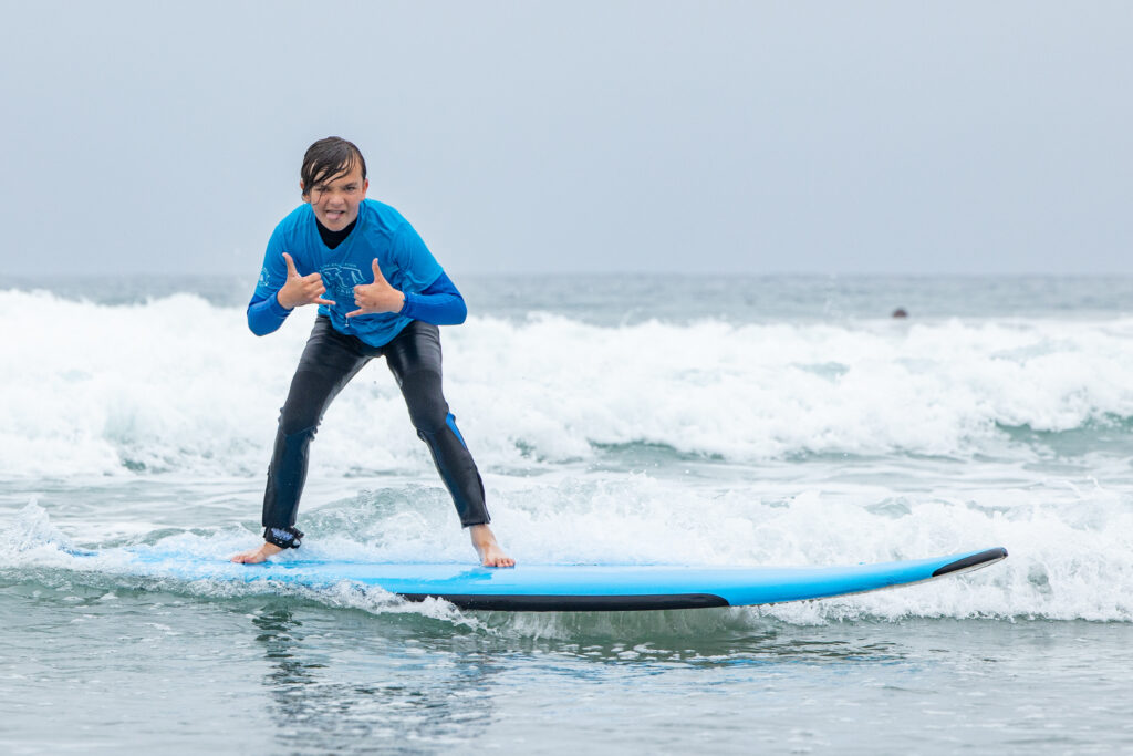 Pre teen surfing at Surf Education Academy surf camp in San Diego at La Jolla Shores