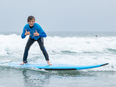 Pre teen surfing at Surf Education Academy surf camp in San Diego at La Jolla Shores