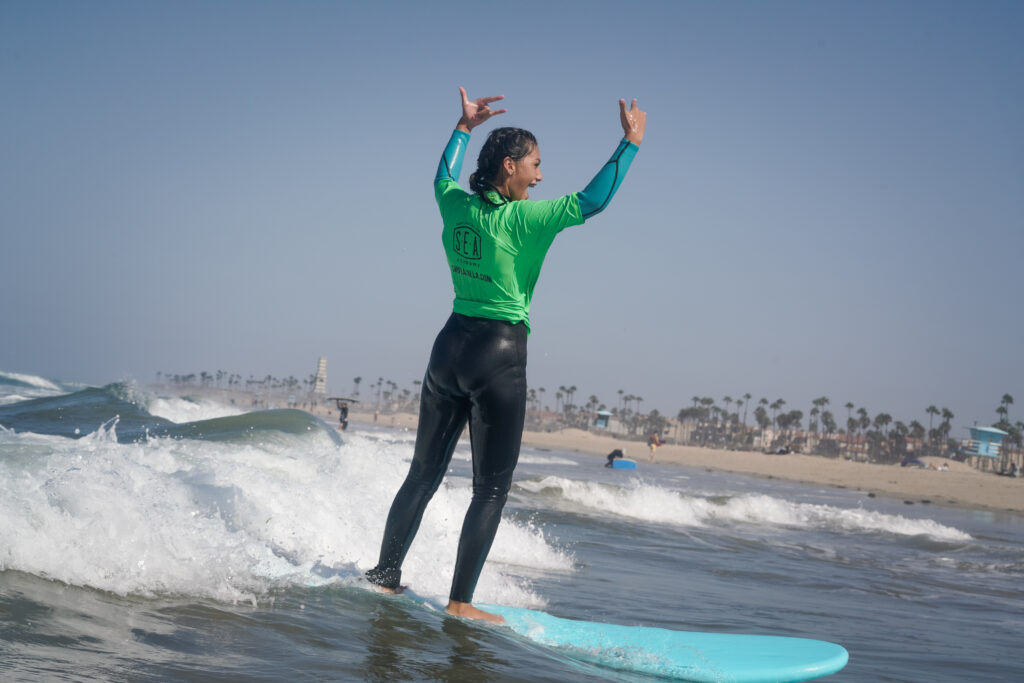 Teen surfing at Surf Education Academy surf camp in San Diego at La Jolla Shores