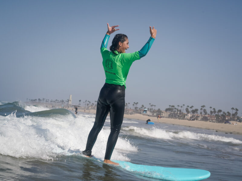 Teen surfing at Surf Education Academy surf camp in San Diego at La Jolla Shores