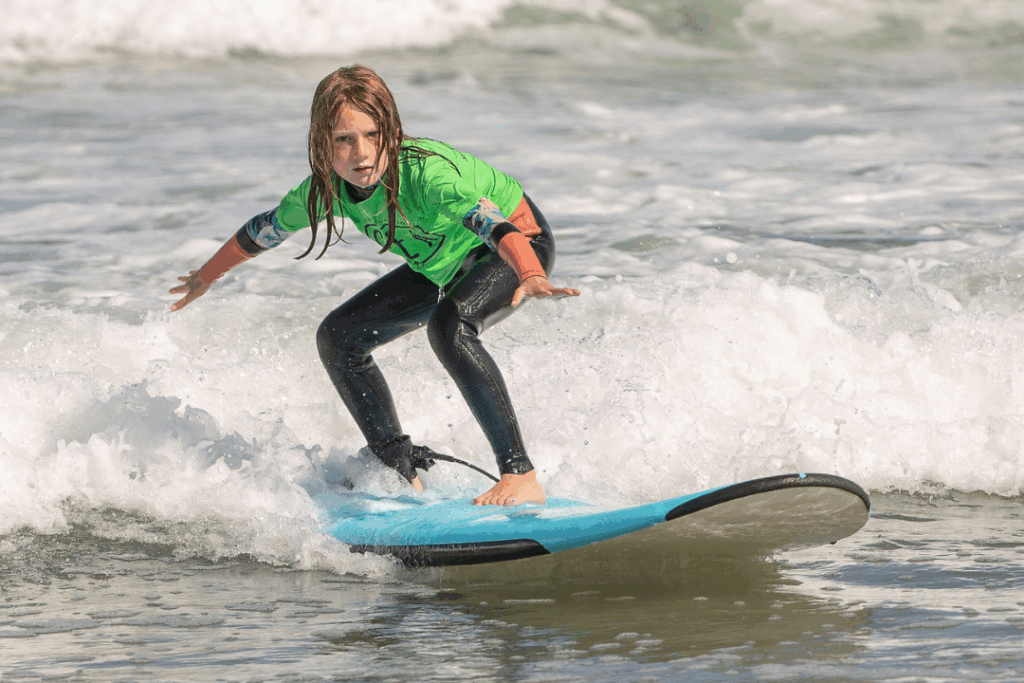 Pre teen surfing at Surf Education Academy surf camp in San Diego at La Jolla Shores