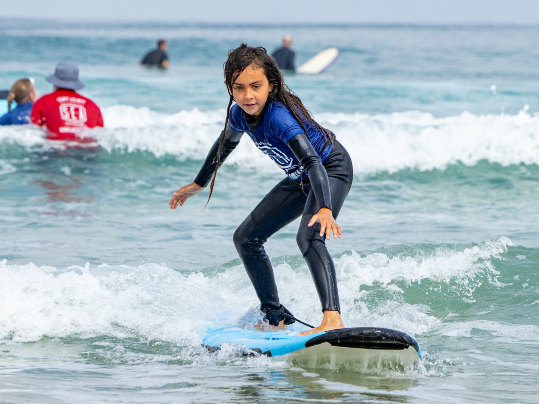 mini grom surfing at Surf Education Academy surf camp in San Diego at La Jolla Shores
