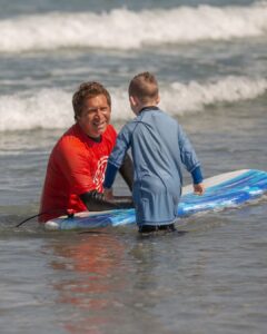 Surf Instructor with Surf Education Academy helping a surf student